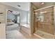 Bright bathroom featuring a soaking tub, walk-in shower with glass door and doorway to the bedroom at 475 Bayswater Way, Suwanee, GA 30024