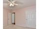 This bedroom features carpet flooring, a ceiling fan and two white doors at 475 Bayswater Way, Suwanee, GA 30024