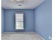 Comfortable bedroom painted blue with a window that allows natural light to fill the room at 475 Bayswater Way, Suwanee, GA 30024