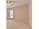 This carpeted bedroom has a ceiling fan and a window for natural light at 475 Bayswater Way, Suwanee, GA 30024