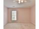 This bedroom has a ceiling fan, carpet floors, a window and neutral walls at 475 Bayswater Way, Suwanee, GA 30024