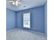 Cozy bedroom painted blue with a window that allows natural light to fill the room at 475 Bayswater Way, Suwanee, GA 30024