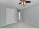 This bedroom features neutral walls, carpet flooring, ceiling fan and access to the hallway at 475 Bayswater Way, Suwanee, GA 30024