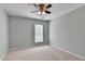 Comfortable bedroom painted gray features ceiling fan and window that allows natural light to fill the room at 475 Bayswater Way, Suwanee, GA 30024