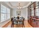 Dining room featuring hardwood floors, tray ceiling, natural light and decorative china cabinet at 475 Bayswater Way, Suwanee, GA 30024