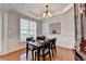 Dining room featuring hardwood floors, tray ceiling, natural light and decorative artwork at 475 Bayswater Way, Suwanee, GA 30024