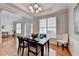 Dining room featuring hardwood floors, tray ceiling, natural light and decorative artwork at 475 Bayswater Way, Suwanee, GA 30024