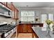 Bright kitchen with stainless appliances, granite counters and door to back patio for easy access for outdoor entertaining at 475 Bayswater Way, Suwanee, GA 30024