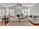 Bright living room features a fireplace, ceiling fan, and plenty of natural light at 475 Bayswater Way, Suwanee, GA 30024