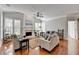 Bright living room features a fireplace, ceiling fan, and plenty of natural light at 475 Bayswater Way, Suwanee, GA 30024
