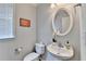 Elegant powder room with white fixtures and stylish decor at 475 Bayswater Way, Suwanee, GA 30024