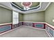 Empty room showcasing wainscoting detail and decorative tray ceiling at 475 Bayswater Way, Suwanee, GA 30024