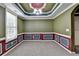 An empty room featuring wainscoting detail and decorative tray ceiling at 475 Bayswater Way, Suwanee, GA 30024
