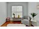 Cozy sitting area with hardwood floors and natural light from the window at 475 Bayswater Way, Suwanee, GA 30024
