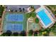 Aerial view shows tennis courts, basketball court and pool, perfect for active lifestyles and community engagement at 475 Bayswater Way, Suwanee, GA 30024