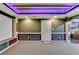 A basement theater room featuring a projection screen and exit door at 475 Bayswater Way, Suwanee, GA 30024
