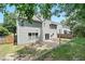 Spacious backyard has green grass, small patio, fenced yard, and shade trees at 4975 Skyland Pkwy, Cumming, GA 30028