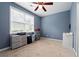 Bedroom featuring a window with blinds and blue paint at 4975 Skyland Pkwy, Cumming, GA 30028