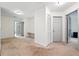 Bright hallway with neutral carpet, white walls, two doors, and a built-in desk at 4975 Skyland Pkwy, Cumming, GA 30028