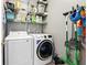 Well-organized laundry room features front load washer and dryer, shelving and gray walls at 4975 Skyland Pkwy, Cumming, GA 30028