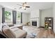 Comfortable living room with a fireplace, neutral tones, and plenty of natural light at 4975 Skyland Pkwy, Cumming, GA 30028