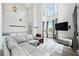 Bright living room boasting soaring ceilings, large windows, and a cozy seating area at 4975 Skyland Pkwy, Cumming, GA 30028