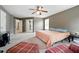 Spacious main bedroom with plush carpet, ceiling fan, and access to the ensuite bathroom at 4975 Skyland Pkwy, Cumming, GA 30028