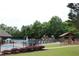 Community swimming pool with a splash pad, playground, and seating areas at 4975 Skyland Pkwy, Cumming, GA 30028