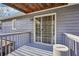 Balcony has grey floors, light grey railing, and a view of the side yard at 130 Thornton Dr, Fayetteville, GA 30214