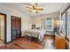 Cozy bedroom featuring a ceiling fan, wood-look flooring, and natural light from the window at 130 Thornton Dr, Fayetteville, GA 30214