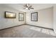Spacious bedroom featuring carpeting, a ceiling fan, and natural light at 130 Thornton Dr, Fayetteville, GA 30214