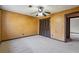 Bedroom boasts neutral carpet, textured yellow walls, and a ceiling fan at 130 Thornton Dr, Fayetteville, GA 30214