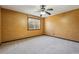 Bedroom boasts neutral carpet, textured yellow walls, and a ceiling fan at 130 Thornton Dr, Fayetteville, GA 30214