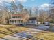 Inviting two-story home featuring a classic front porch, a well-maintained lawn, and a long driveway at 130 Thornton Dr, Fayetteville, GA 30214
