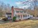 Charming two-story home with a welcoming front porch, classic shutters, and a vibrant red front door at 130 Thornton Dr, Fayetteville, GA 30214