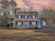 Inviting two-story home with a cozy front porch, perfect for enjoying the outdoors at sunset at 130 Thornton Dr, Fayetteville, GA 30214