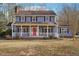 Charming two-story home with a welcoming front porch and a vibrant red front door at 130 Thornton Dr, Fayetteville, GA 30214
