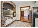 Cozy kitchen features custom brick accents, stainless appliances and tile floors at 130 Thornton Dr, Fayetteville, GA 30214