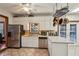 Bright kitchen features stainless steel appliances, white cabinets and tile floors at 130 Thornton Dr, Fayetteville, GA 30214