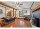 Spacious living room with a fireplace, wooden beams, and an open floor plan with laminate floors at 130 Thornton Dr, Fayetteville, GA 30214