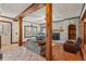 Open living room with painted brick fireplace, wood burning insert and beam accents at 130 Thornton Dr, Fayetteville, GA 30214