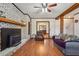 Inviting living room featuring a white brick fireplace, wood mantel, and comfortable seating arrangement at 130 Thornton Dr, Fayetteville, GA 30214