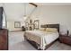 Spacious main bedroom features a brick fireplace, a ceiling fan, and natural light at 130 Thornton Dr, Fayetteville, GA 30214
