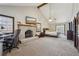 Spacious main bedroom boasts a cozy fireplace, ceiling fan, and a work space at 130 Thornton Dr, Fayetteville, GA 30214