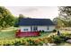 Lovely home featuring a deck and large yard surrounded by lush trees at 210 Overview Ct, Villa Rica, GA 30180