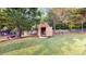 View of backyard shed with shelving and a dog near the fence line at 210 Overview Ct, Villa Rica, GA 30180
