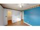 Bright bedroom featuring blue accent wall, ceiling fan, and closet with shelving at 210 Overview Ct, Villa Rica, GA 30180