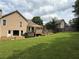 Backyard view with patio and well-maintained lawn and landscaping at 2193 Kildare Nw Way, Kennesaw, GA 30152