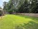 Spacious backyard with lush green lawn and mature trees, perfect for outdoor activities at 2193 Kildare Nw Way, Kennesaw, GA 30152