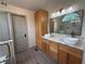 Bathroom with double sinks, modern lighting fixtures, and a walk-in shower at 2193 Kildare Nw Way, Kennesaw, GA 30152